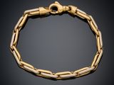 a gold bracelet with a chain link on a black background