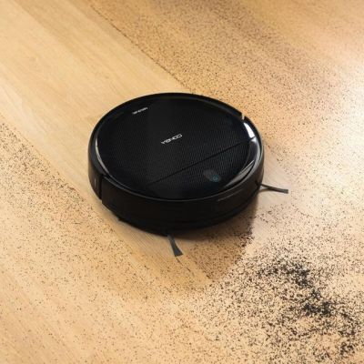 a close up of a black robot on a wooden floor