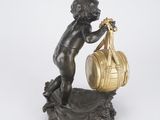 bronze figurine of a boy holding a barrel and a basket