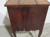 a small wooden table with a chess board on top of it