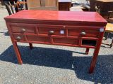 a red table with drawers and drawers on it