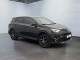 a grey toyota rav is parked in a large room