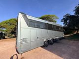 a trailer that is parked on a dirt road