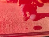 a reflection of a person sitting on the ground in front of a mirror