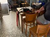 a man that is sitting at a table in a room