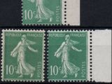 four different stamps with a woman on them on a black surface