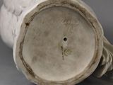 a white vase that is sitting on a table