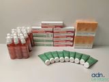many bottles of liquid and a box of medicine on a table