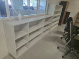 a room with a desk, chair, and bookshelf in it