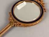 a gold mirror with a blue border and a label on it