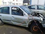 a car that has been badly damaged and is parked on the side of the road
