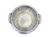 a silver bowl with a metal lid on a white surface