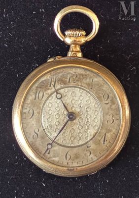a gold pocket watch on display on a black surface