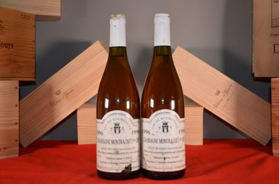 two bottles of wine sitting next to each other on a table