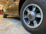 a car that is parked in a garage with it ' s wheels on