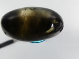 a picture of a close up of a spoon with a liquid inside of it