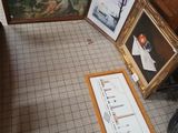 several framed pictures are on the floor in a room