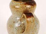 a small vase that is sitting on a white surface