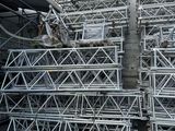 a large pile of metal scaffolding in front of a building
