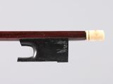 a close up of a violin bow on a white surface