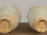 two vases that are sitting on a table