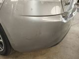 a car that has been painted silver in a garage