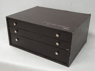 a small black box with four drawers on it
