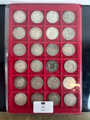 a display case with a lot of silver coins in it