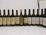 several bottles of wine are lined up in a row on a table