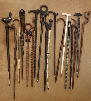 many different types of walking canes on a brown surface