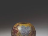 a glass vase with a design on it sitting on a table