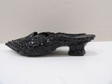 a black shoe that is sitting on a table