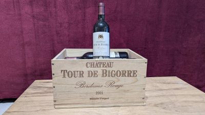a wooden box with a bottle of wine inside of it