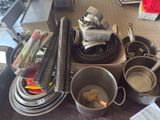 many pots and pans on the counter in the kitchen