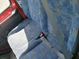 two seats in the back of a car with a blue seat cover
