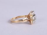 a close up of a diamond ring on a white surface