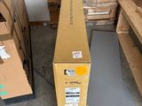 a cardboard box sitting on the floor next to a pile of boxes