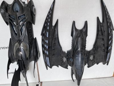 two black bats that are hanging on the wall