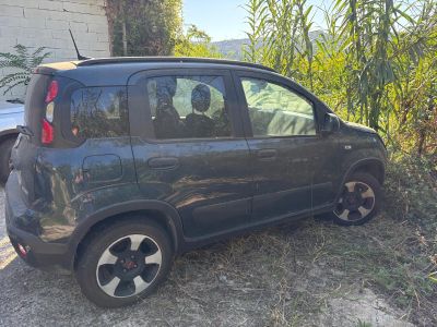 a small black car parked on the side of the road