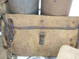 a brown bag sitting on top of a pile of old luggage