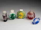 six small glass bottles with different colors and designs on them