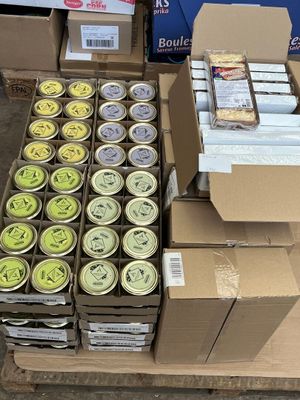 boxes of canned food are stacked on a pallet in a warehouse