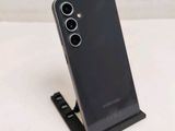 a close up of a cell phone on a stand on a table