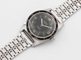 rolex a lady ' s stainless steel bracelet watch with black dial