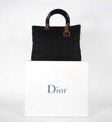 a black and white bag sitting on top of a white box
