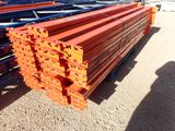 a pile of orange beams sitting on the ground