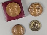 three coins are sitting next to each other on a white surface