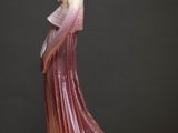 an image of a figurine of a woman in a purple dress