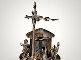 an image of a silver figurine of a boat with animals on it