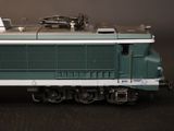 a toy train on a black table with a black background